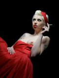 Tattooed blonde Lynn Pops in long red dress smokes and shows her natural tits