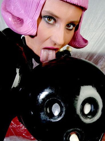 Kinky Peggy Sue and one more european latex girl playing with rubber doll