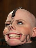 Bald chick Alani Pi gets her mouth stretched and her pink nipples pinched