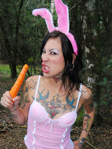 Bunny girl Ruby EroticBPM eats carrot and shows her tattooed body outdoors
