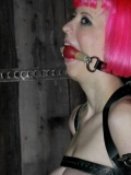 Amber Rayne gets bent over and analized in front of pink haired slave girl Cherry Torn.