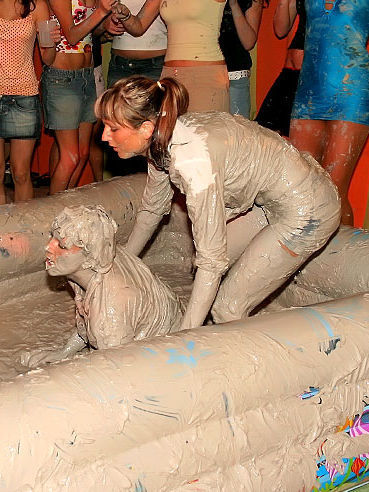 Christina Lee and her opponent bare their lovely boobies during public muddy wrestling