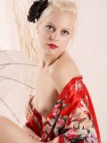Blonde Caz with black flower in her hair loses her red asian dressing gown a