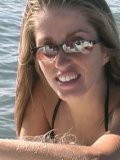 Bikini girl Lori Anderson in sunglasses gives a close-up of her body hair by the lake