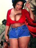 Chunky black woman Emage in hat takes off her jean shorts and bares her massive dark tits