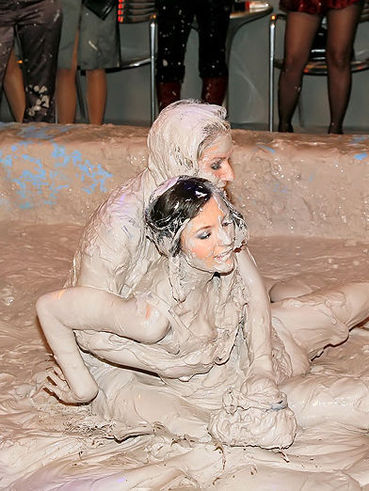 Enthusiastic Miss Skinny wrestles in mud in front of drunk party ladies