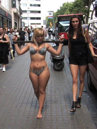 The half naked bimbo Yillie Fresh is made to walk enchained over the streets