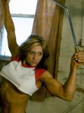 Muscle girl Danielle Rouleau does exercises in the gym room flashing her big firm tits