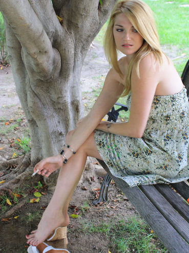 Shoeless blonde Kelly Space in nice summer dress shows off her lovely feet outdoors