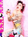 Nude inked up Michelle Aston posing in bed with multiple plush teddy bears 