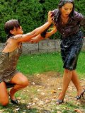 Brunette Samantha Wow takes part in egg fight with another clothed woman in the backyard