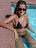 Long haired Lori Anderson in black bikini and sunglasses shows off her hairy arms in the pool