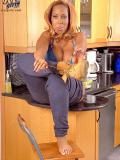 Chunky dark skinned lady Deja shows her big sized blue bra in the middle of the kitchen