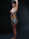 Completely naked brunette mom Michelle Aston exposes her color tattoo in the dark