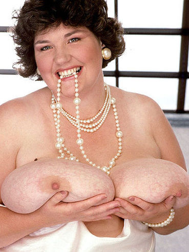 Middle aged fattie Sandra Simms in white silk nightie bares her monstrous tits