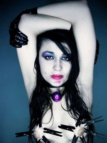 Kinky black haired goth girl Sophia Jade poses with clothespins on her tits