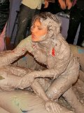 Tatiana Milovani gets the mud wrestling match started with her red blouse on