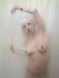 Flirtatious white haired goth girl Lynn Pops demonstrates her boobs in the shower